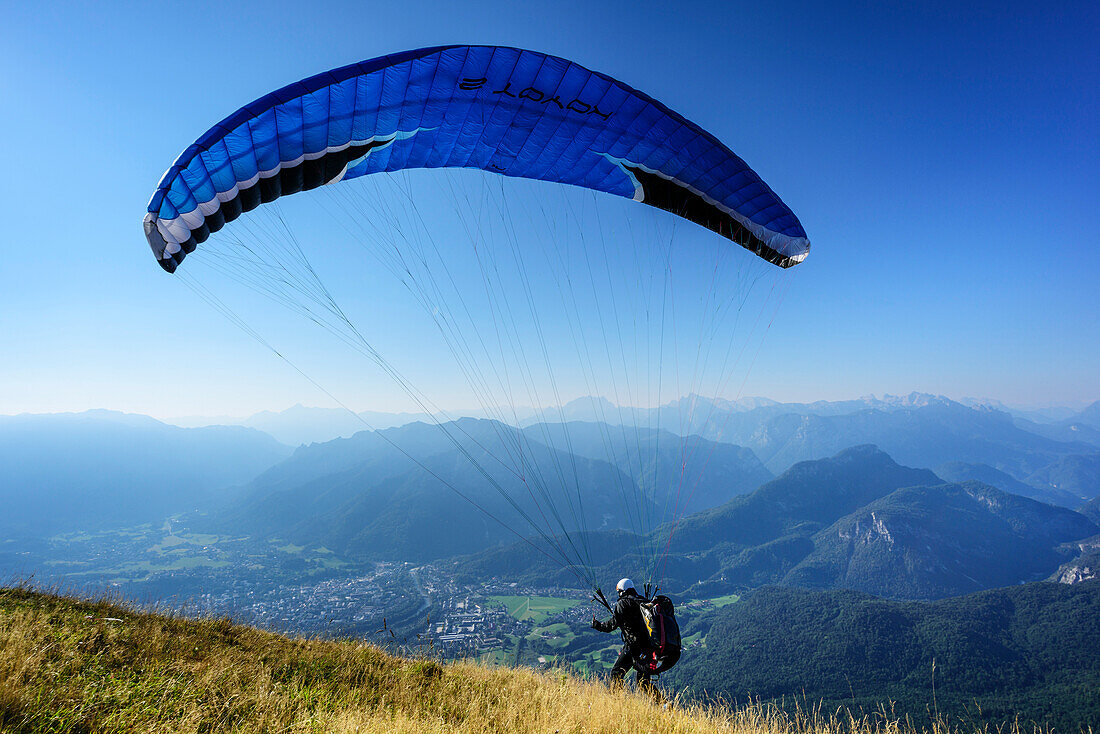 Paraglider starting at Mittelstaufen, view to Bad Reichenhall, Mittelstaufen, Chiemgau Alps, Upper Bavaria, Bavaria, Germany