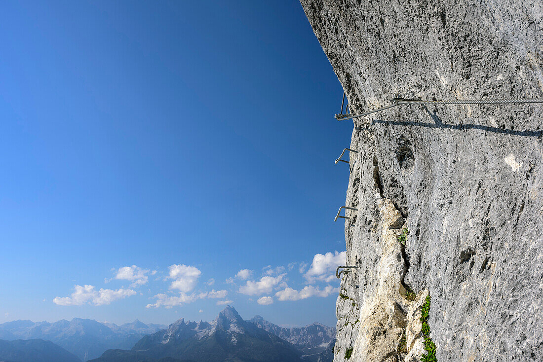 Fixed rope leading through rockface, Watzmann in background, Hochthronklettersteig, fixed rope route Hochthron, Untersberg, Berchtesgadener Hochthron, Berchtesgaden Alps, Upper Bavaria, Bavaria, Germany