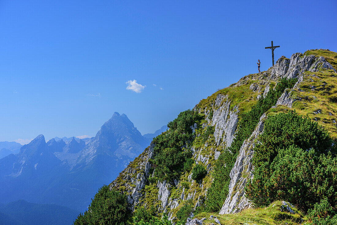 Person standing at summit of Hochthron, Watzmann in background, Untersberg, Berchtesgadener Hochthron, Berchtesgaden Alps, Upper Bavaria, Bavaria, Germany