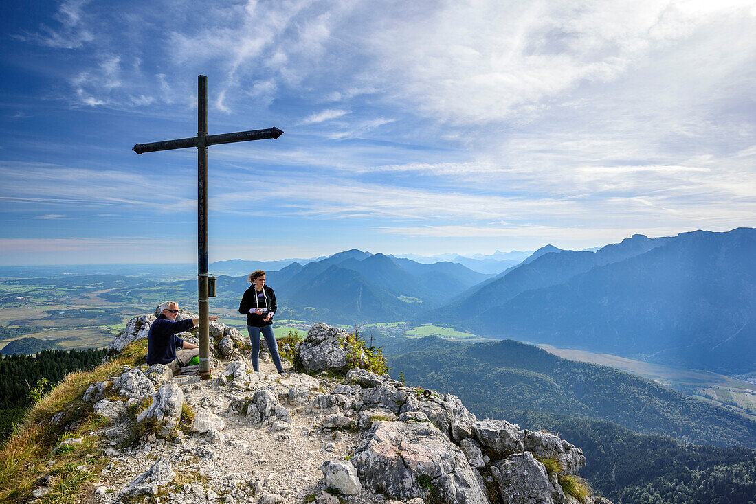Two persons hiking at Ettaler Manndl, Ester range in background, Ettaler Manndl, Ammergauer Alps, Upper Bavaria, Bavaria, Germany