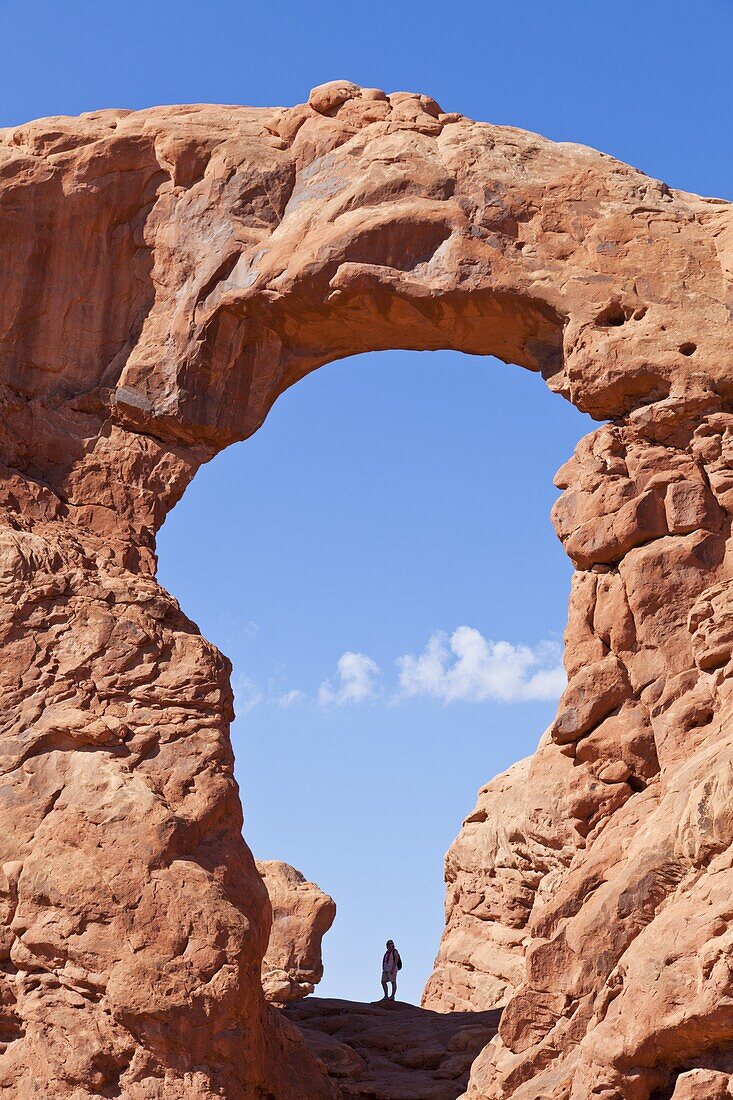 Lone hiker in Turret Arch, Arches National Park, near Moab, Utah, United States of America, North America