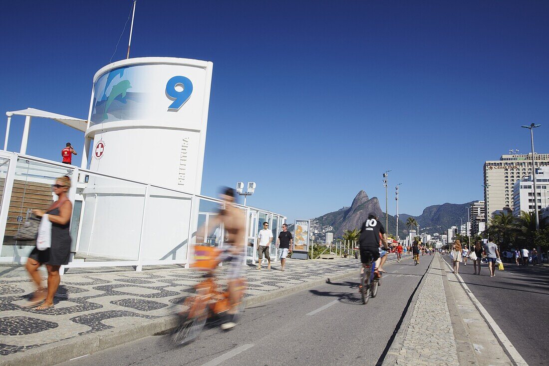 People cycling and walking along pedestrianised street on Sunday, Ipanema, Rio de Janeiro, Brazil, South America