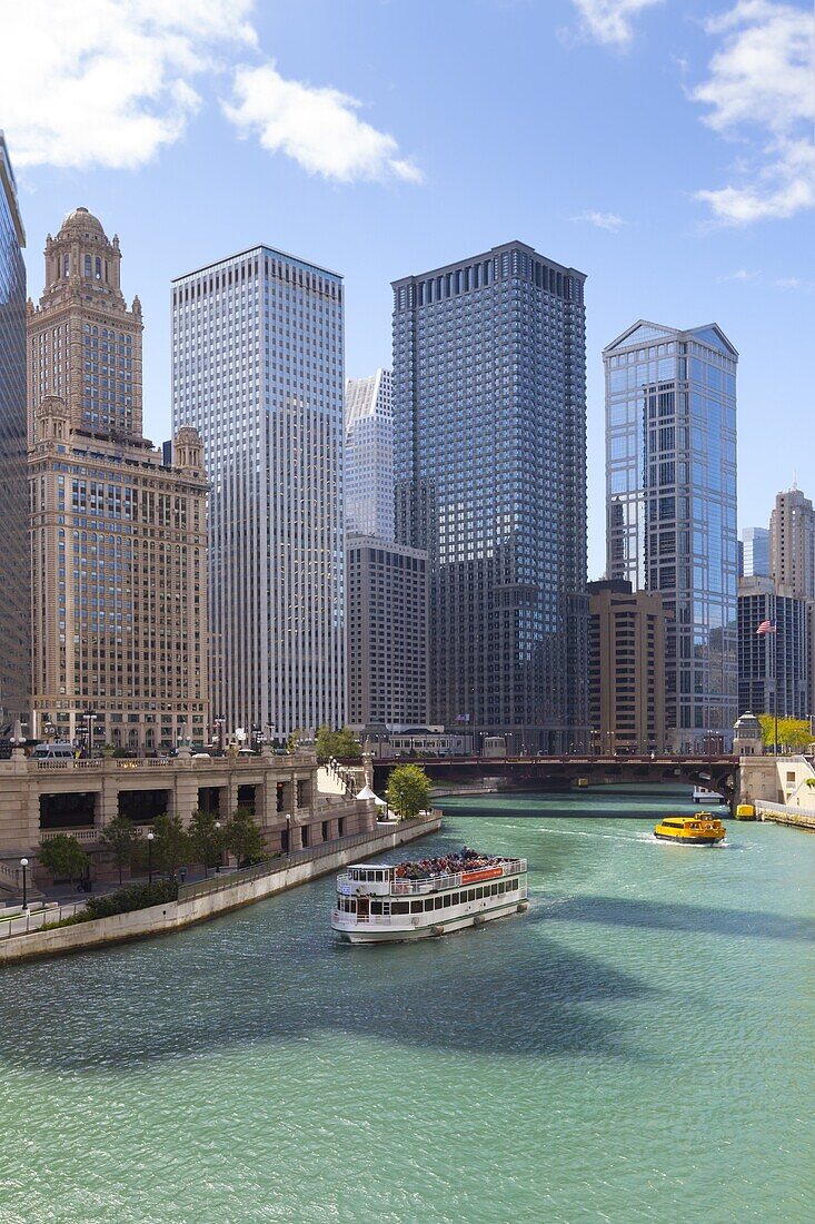Tourist boat on the Chicago River with glass towers behind on West Wacker Drive, Chicago, Illinois, United States of America, North America