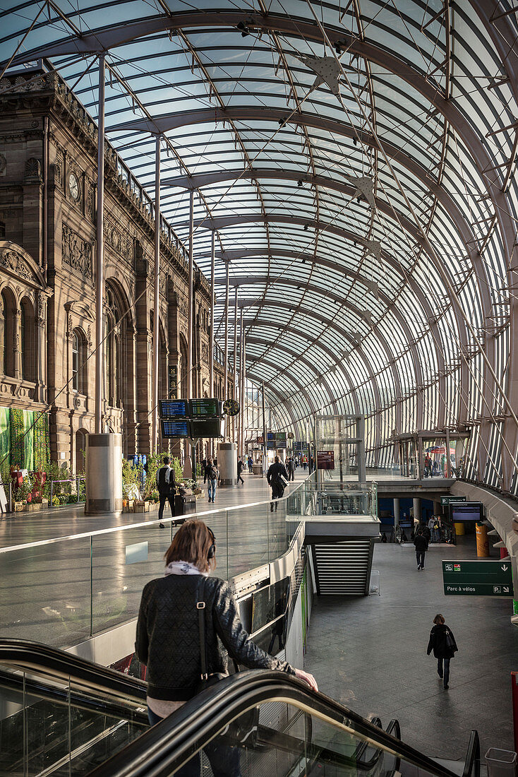 Train traveler on the escalators at the central station, Strasbourg, Alsace, France