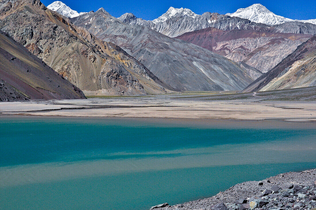 'Glacial lake and reservoir Embalse el yeso and colorful mountains, Valle del Yeso, Cajon del Maipo, Región Metropolitana de Santiago, Andes, Chile;'