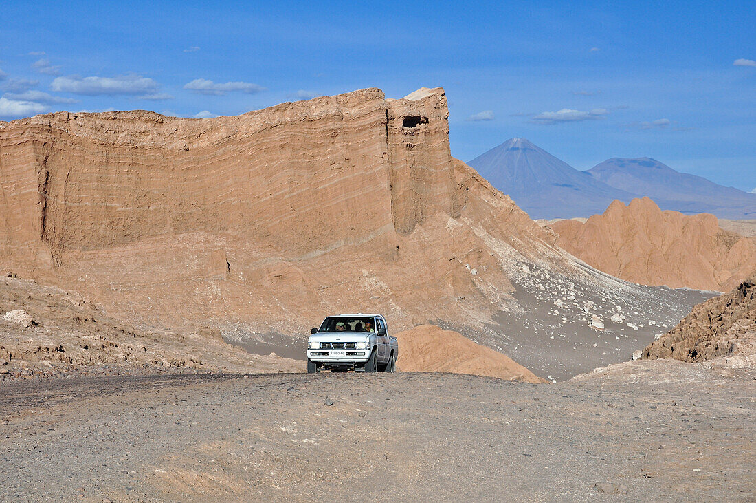 Jeep on track between mountains and rock formations, Valle de la Luna, Valley of the moon, Atacama desert, National Reserve, Reserva Nacional Los Flamencos, Region de Antofagasta, Andes, Chile, South America