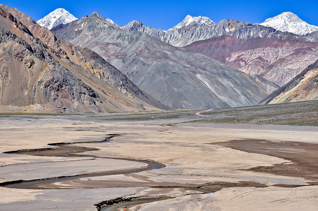 'Colorful mountains and river valley of Rio Yeso, Valle del Yeso, Cajon del Maipo, Región Metropolitana de Santiago, Andes, Chile;'