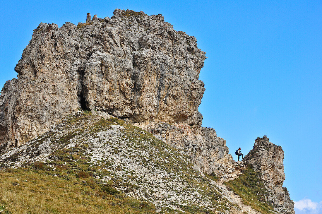 Young woman hiking at rock formation near the mountain Rotwand, part of Rosengarten, Catinaccio, St. Zyprian, Tiers, Tiers Valley, Nature Park Schlern Rosengarten, Dolomites, South Tyrol, Alto Adige, UNESCO world heritage side, Italy, European Alps, Europ