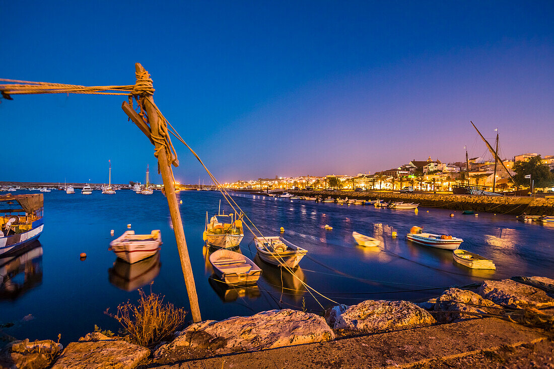 View from harbour towards old town at twilight, Lagos, Algarve, Portugal