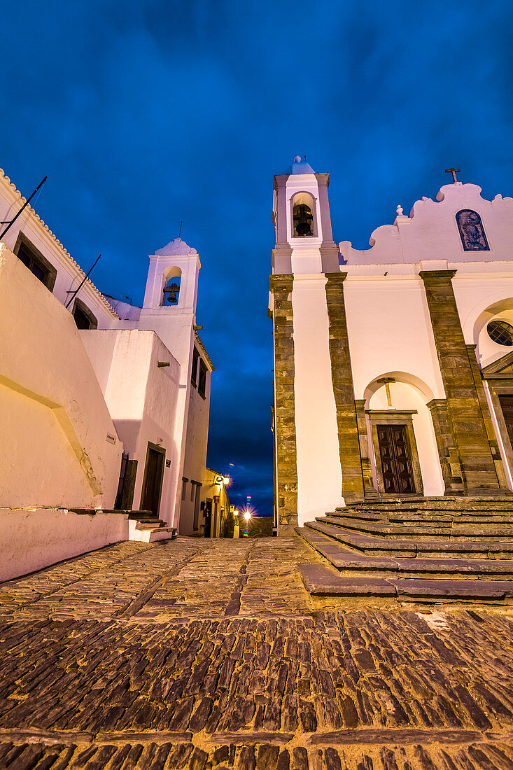 Old town at twilight with illuminated church, Monsaraz, Alentejo, Portugal