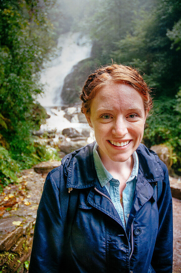 Woman at Tork waterfall in Killarney national park.