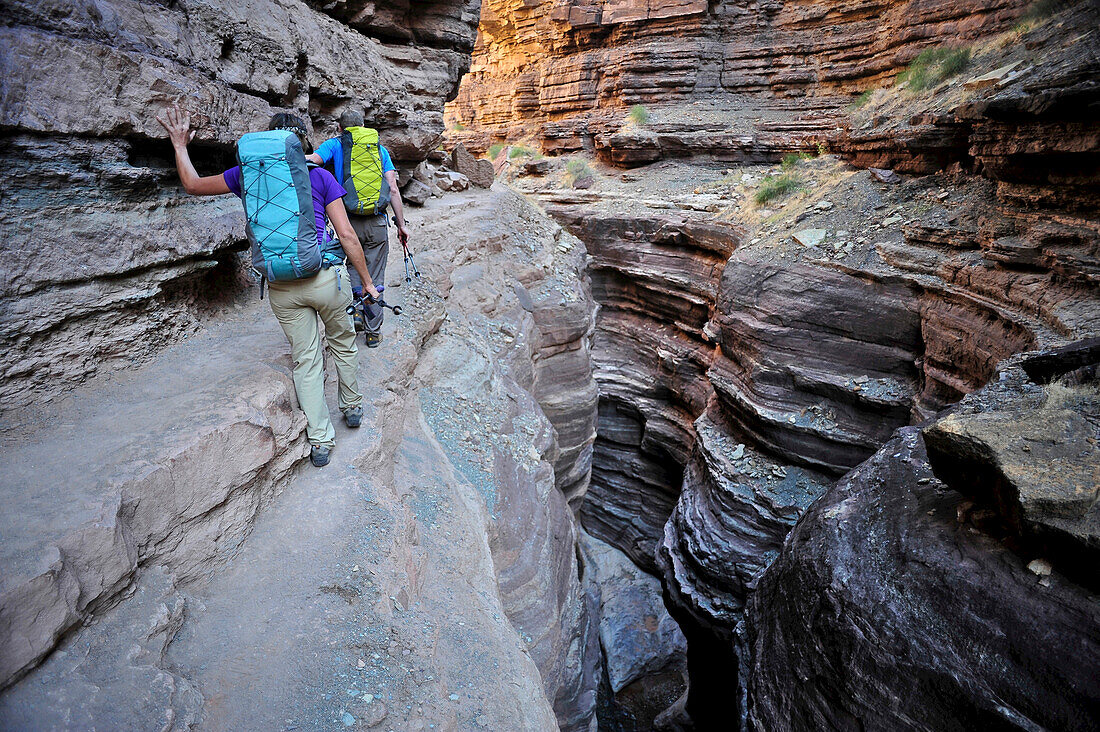 Hikers walk along Deer Creek Narrows in the Grand Canyon outside of Fredonia, Arizona November 2011.  The 21.4-mile loop starts at the Bill Hall trailhead on the North Rim and descends 2000-feet in 2.5-miles through Coconino Sandstone to the level Esplana