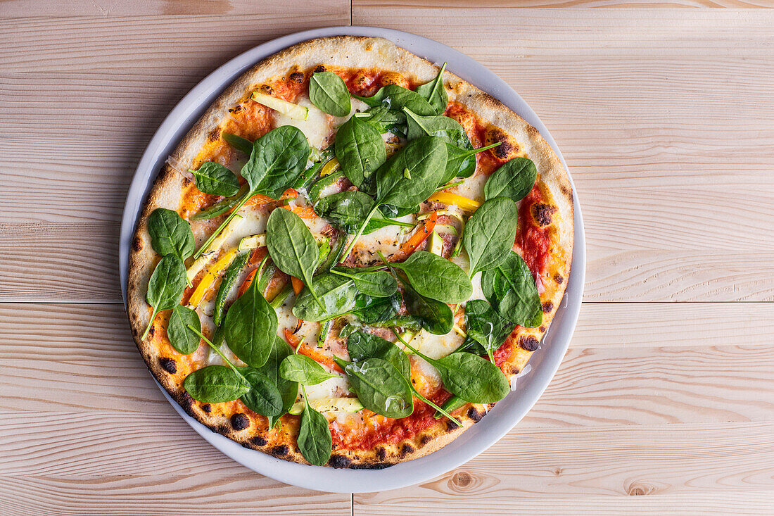 Close up of pizza with fresh spinach