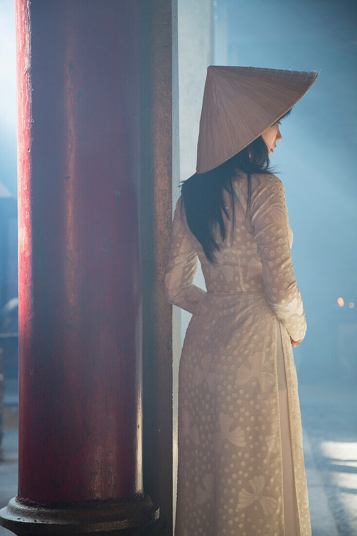 Woman wearing ao dai dress at Thien Hau Pagoda, Cholon, Ho Chi Minh City, Vietnam, Indochina, Southeast Asia, Asia