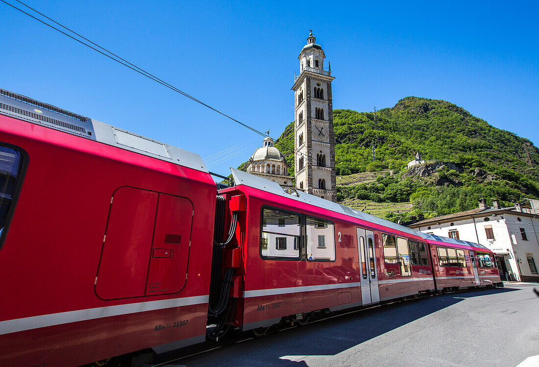 The Bernina Express train passes near the Sanctuary of Madonna di Tirano, not far from the Swiss border, on the UNESCO World Heritage Site railway, Lombardy, Italy, Europe