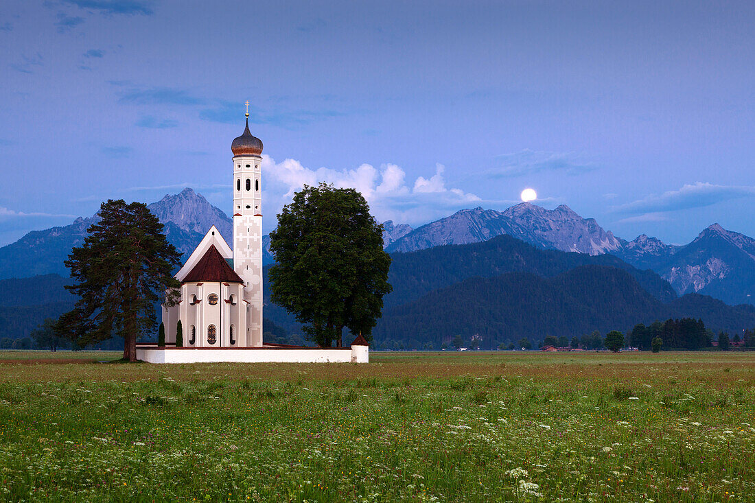 St Coloman pilgrimage church near Schwangau at full moon, view to Tannheimer Berge, Allgaeu, Bavaria, Germany