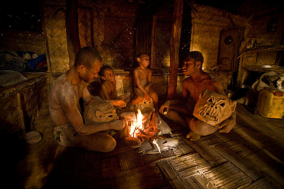 Goroka mudmen gathered around a fireplace, Goroka, Eastern Highlands, Papua New Guinea
