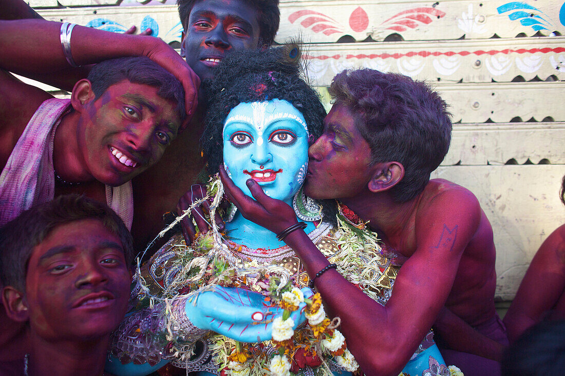 Men painted red during Holi festival, Kolkata, West Bengal, India