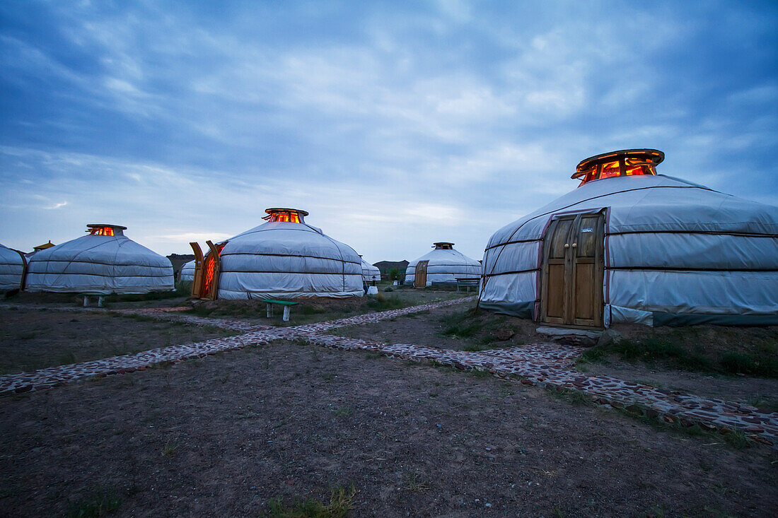 Mongolian Gers (yurts) tourist accommodation at the Ongiin Nuts Ger Camp at dusk, Saikhan-Ovoo, Dundgovi Province, Mongolia