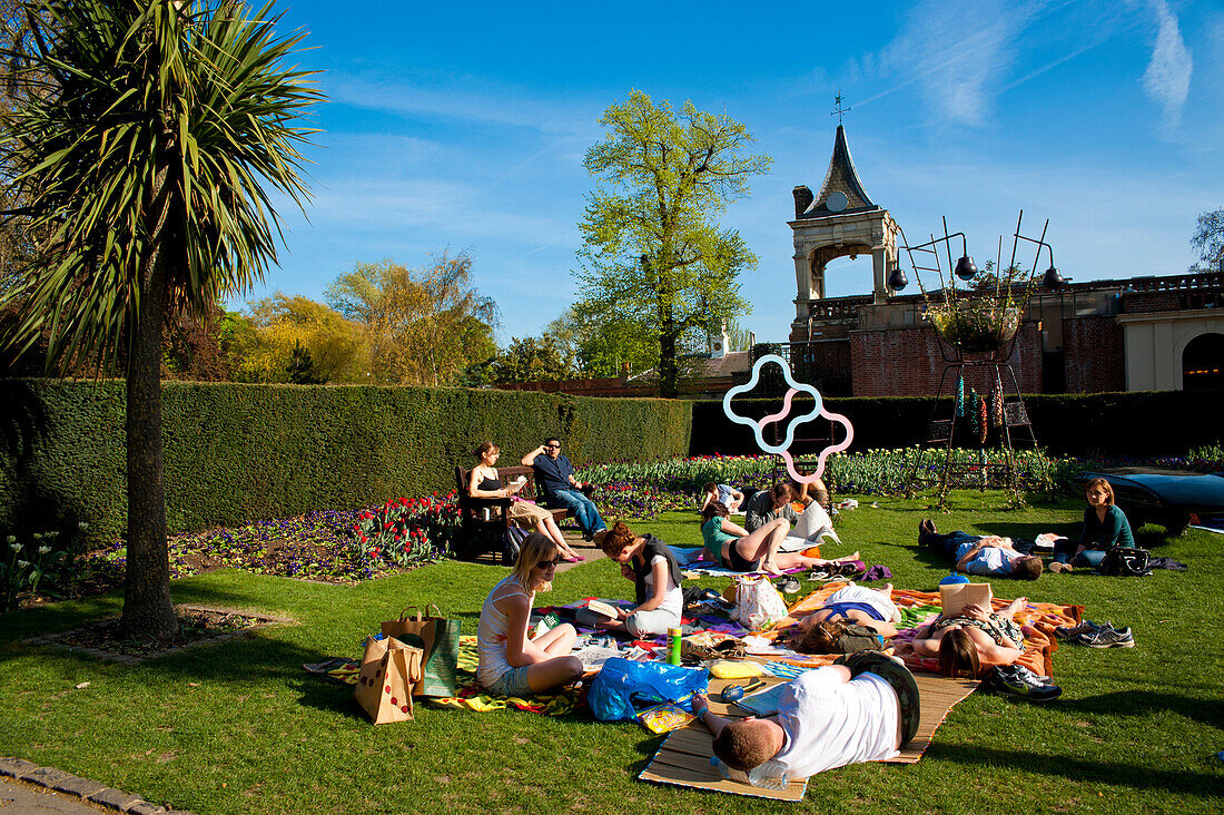 People Sunbathing On A Spring Day In Holland Park, West London, London, Uk