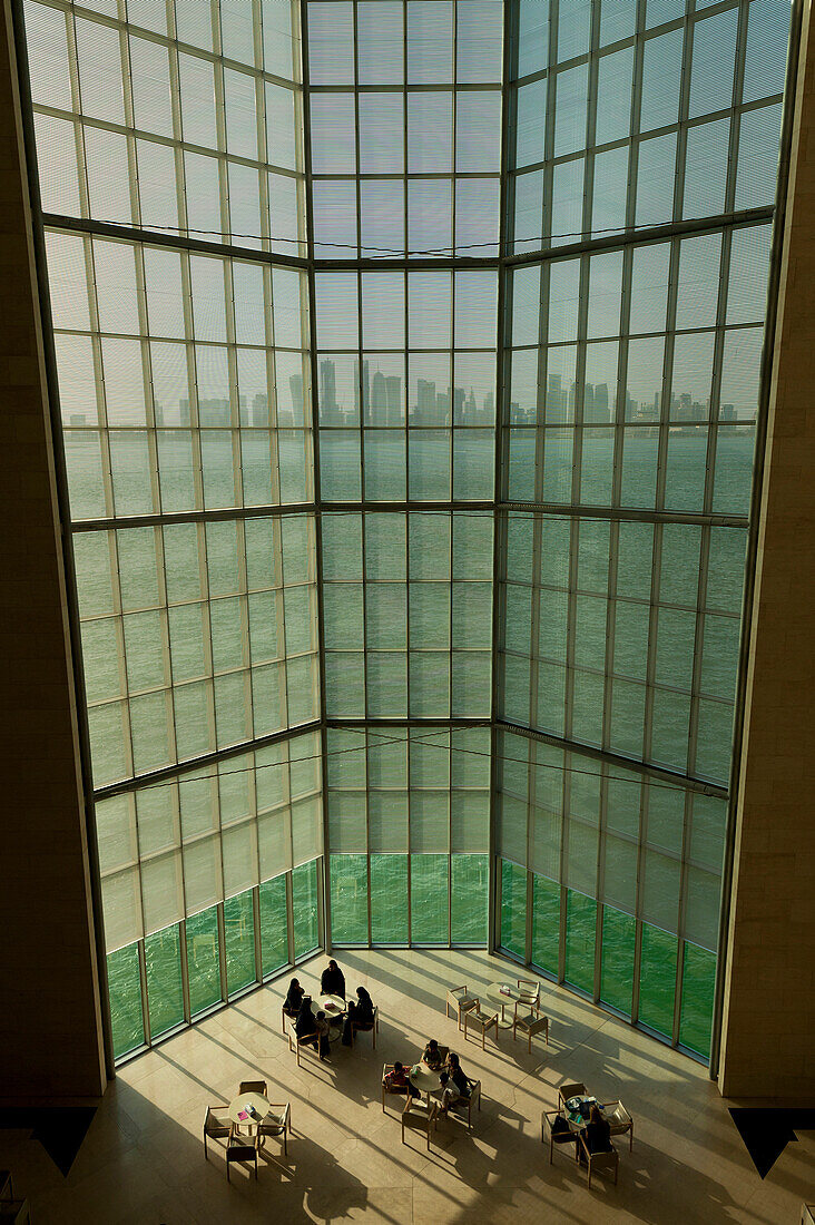 View out of large window in the Museum of Islamic Art to the modern city skyline of Doha, Doha, Qatar