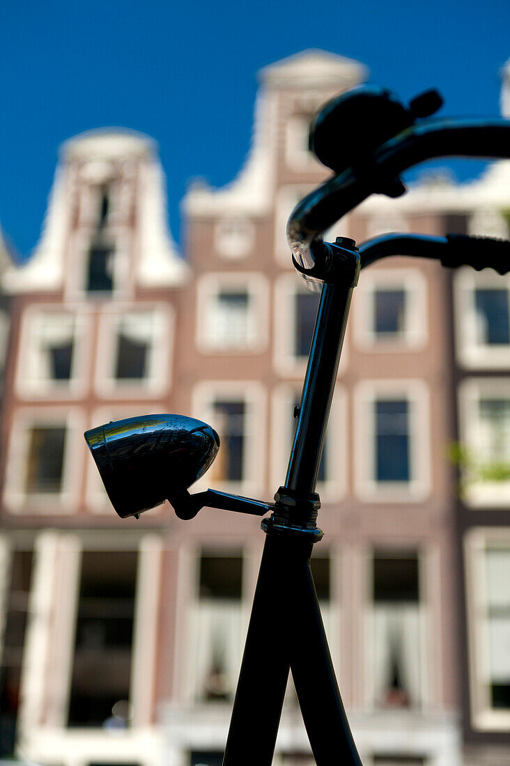 Detail of handelbars of Dutch bicycle in front of gabled houses, Amsterdam, Holland