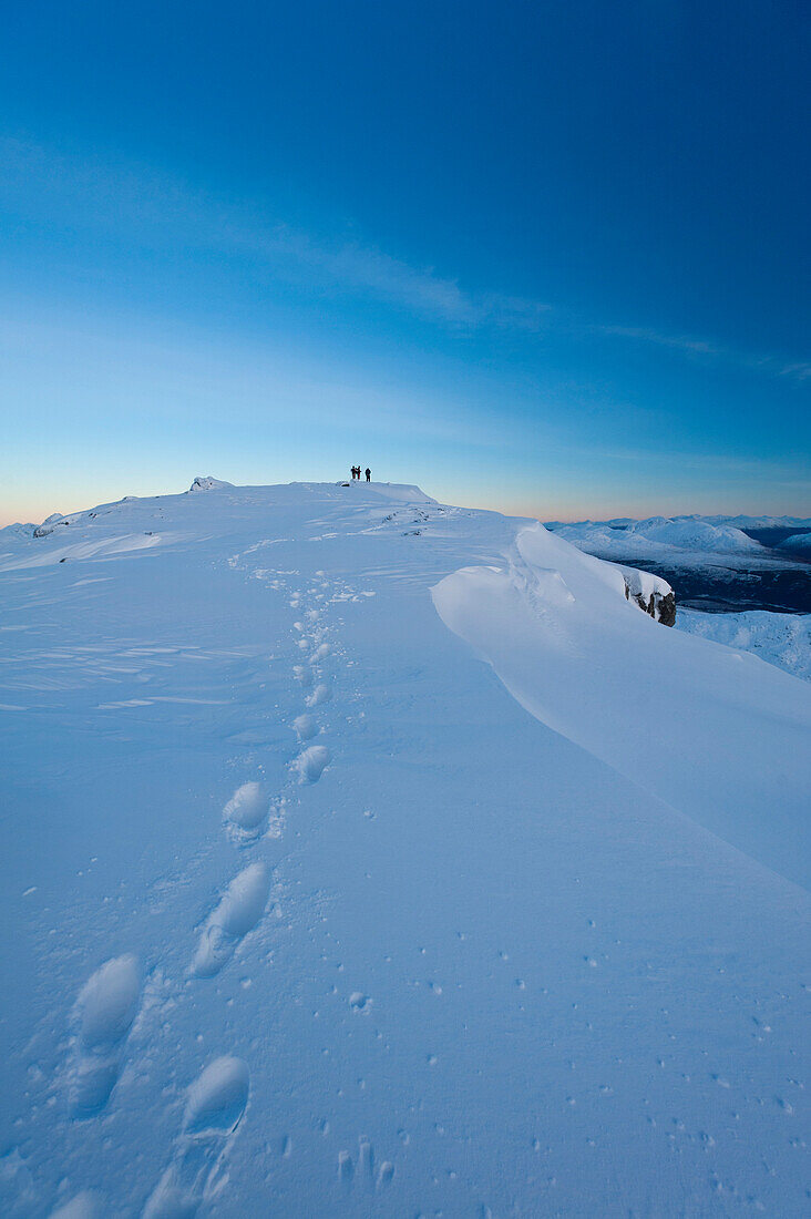 Footprints in the snow on the summit of Beinn Respiol at dusk, Ardnamurchan peninsula, Highlands, Scotland