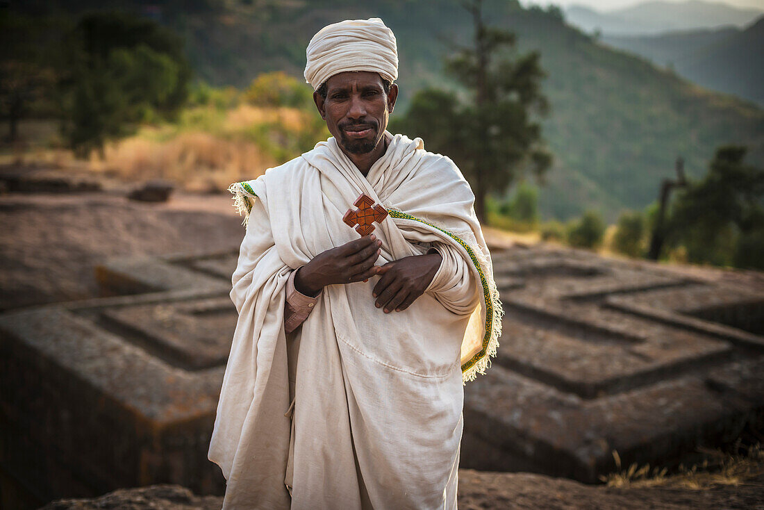 Ethiopian Orthodox Christian pilgrim with cross, Lalibela, Ethiopia