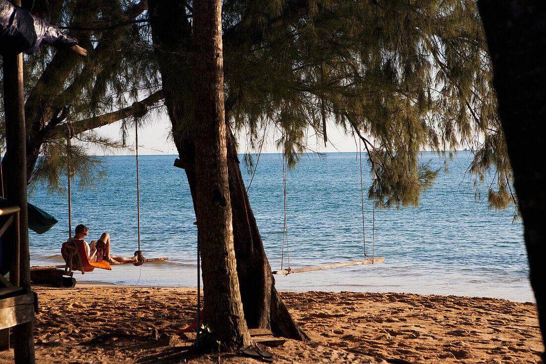 Relaxing on a beach swing, Bamboo Island, Cambodia