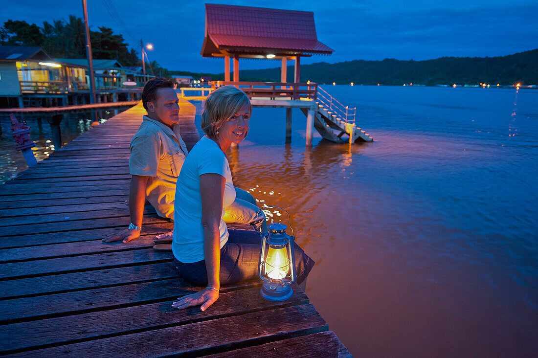 Tourists relaxing at dusk in a small village, Brunei