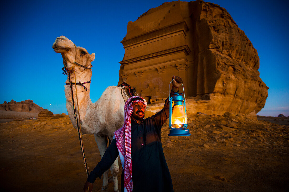 Camel and rider with Madain Saleh in the background, Madain Saleh, Saudi Arabia