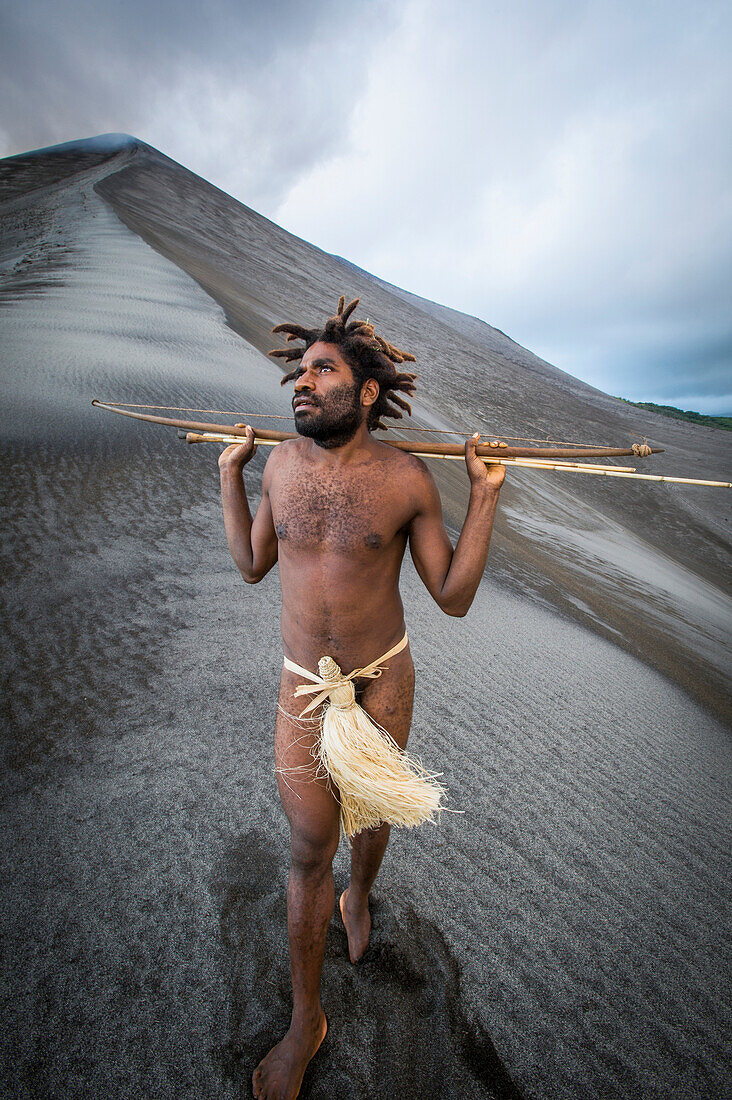 Ni-Vanuatu man with arrows at the base of Yasur Volcano, Tanna Island, Vanuatu