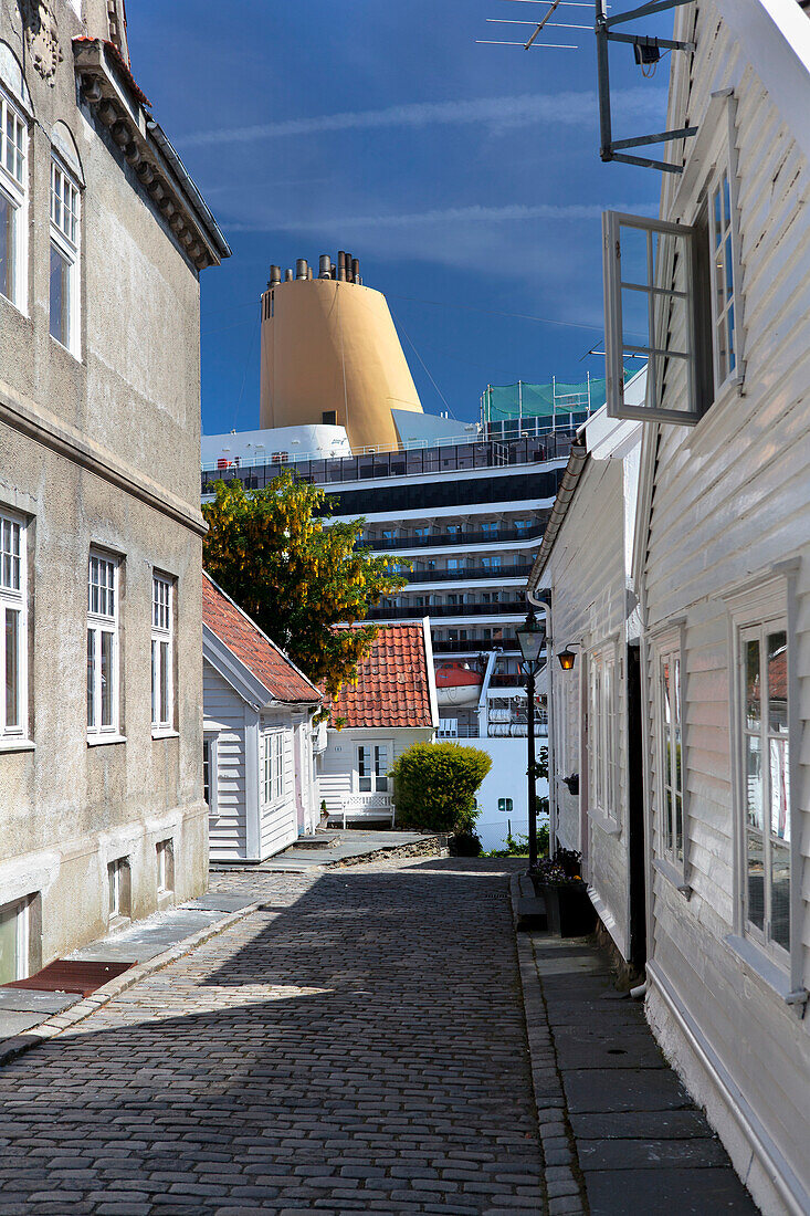 'Cruise ship docked at Stavanger, viewed down narrow side street; Stavanger, Norway'