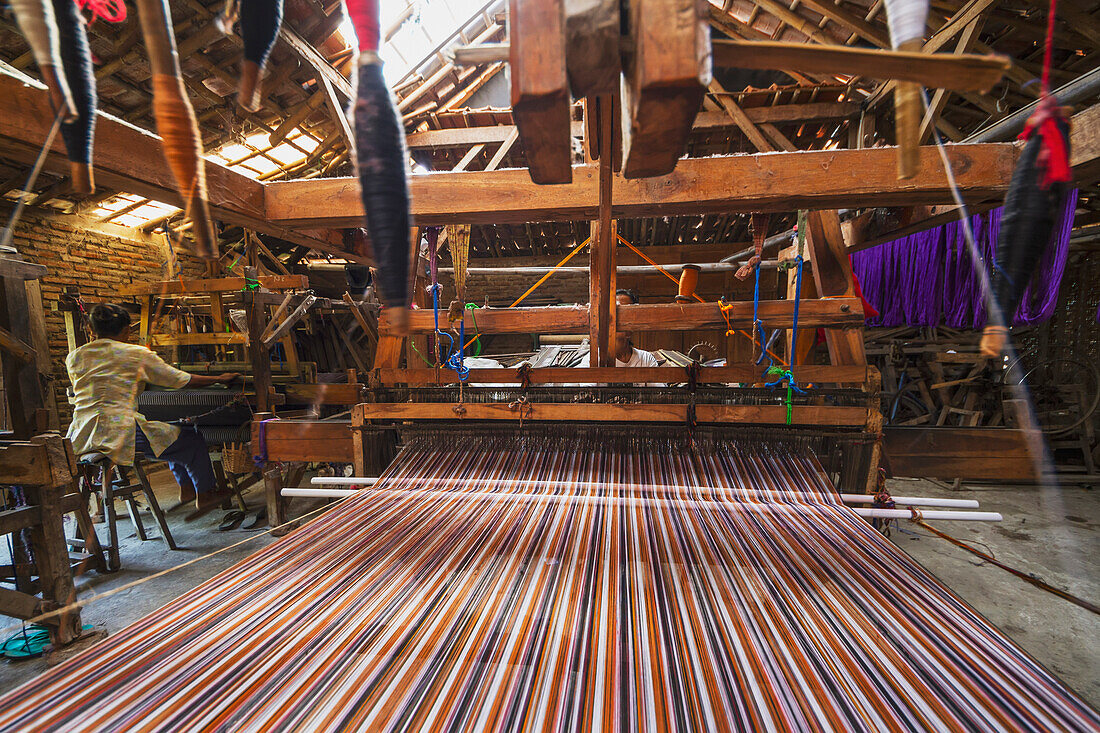 Traditional Lurik cloth being woven on a loom in a lurik workshop in Cawas village, Klaten, Central Java, Indonesia