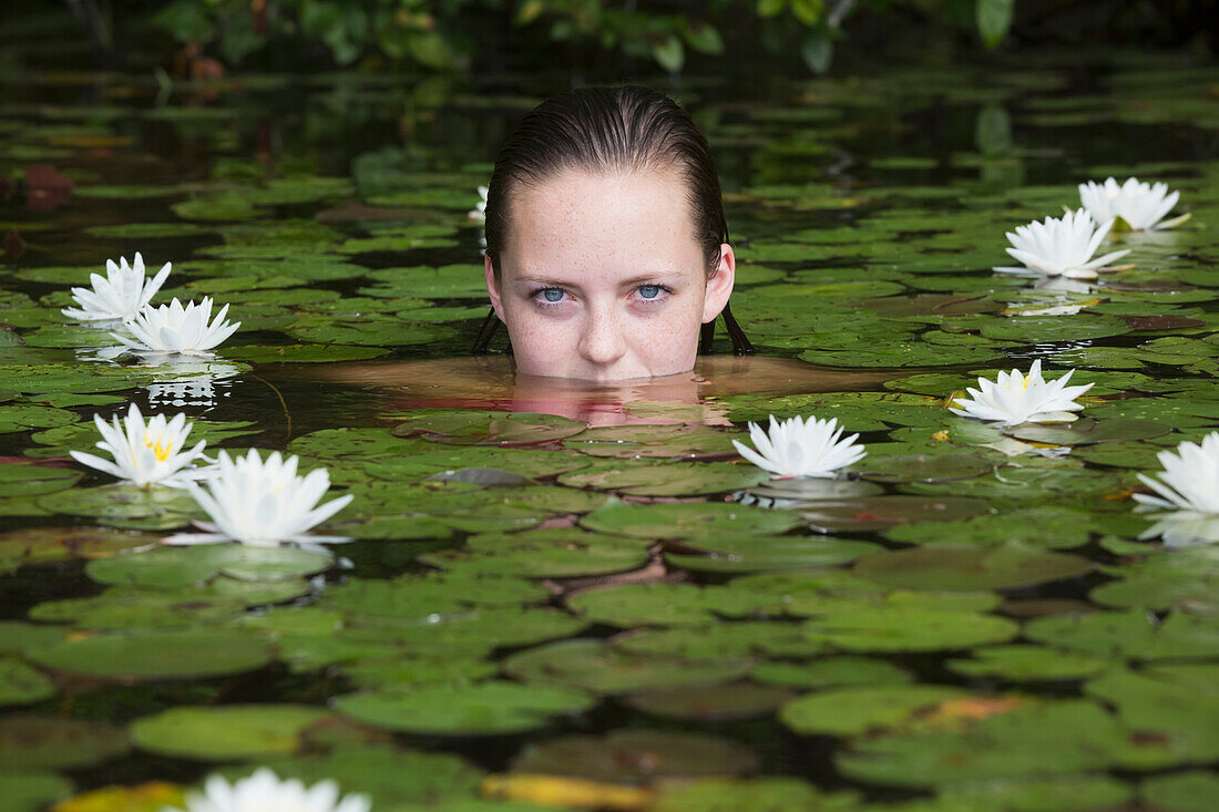 'Young woman in water among the water lilies; Connecticut, United States of America'