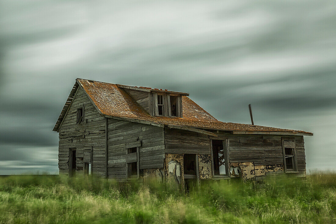 'Long exposure of clouds going over an abandoned house; Val Marie, Saskatchewan, Canada'