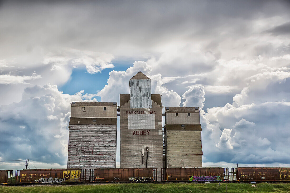 'Rural grain elevator with cumulonimbus clouds building up around it; Saskatchewan, Canada'