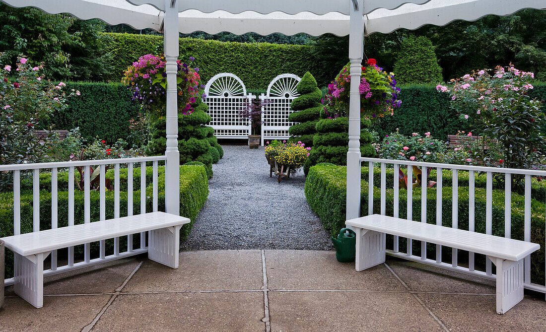 'White gazebo with hanging flower baskets in Minter Gardens; Rosedale, British Columbia, Canada'