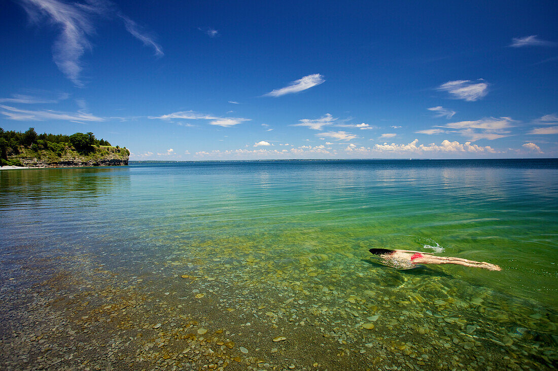 'Woman swimming in Lake Ontario; Little Bluff, Ontario, Canada'