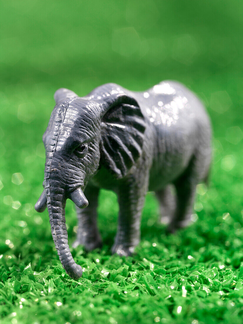 Close Up Of Miniature Toy Elephant On Artificial Grass