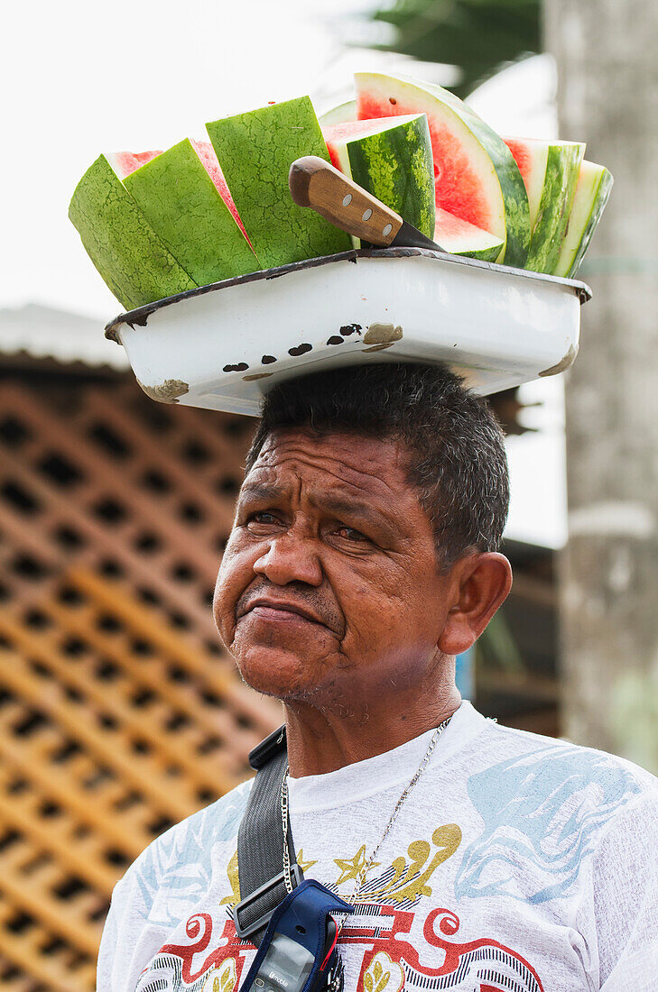 Man carrying a tray with sliced watermelon pieces on his head, San Jacinto de Yaguachi, Guayas, Ecuador