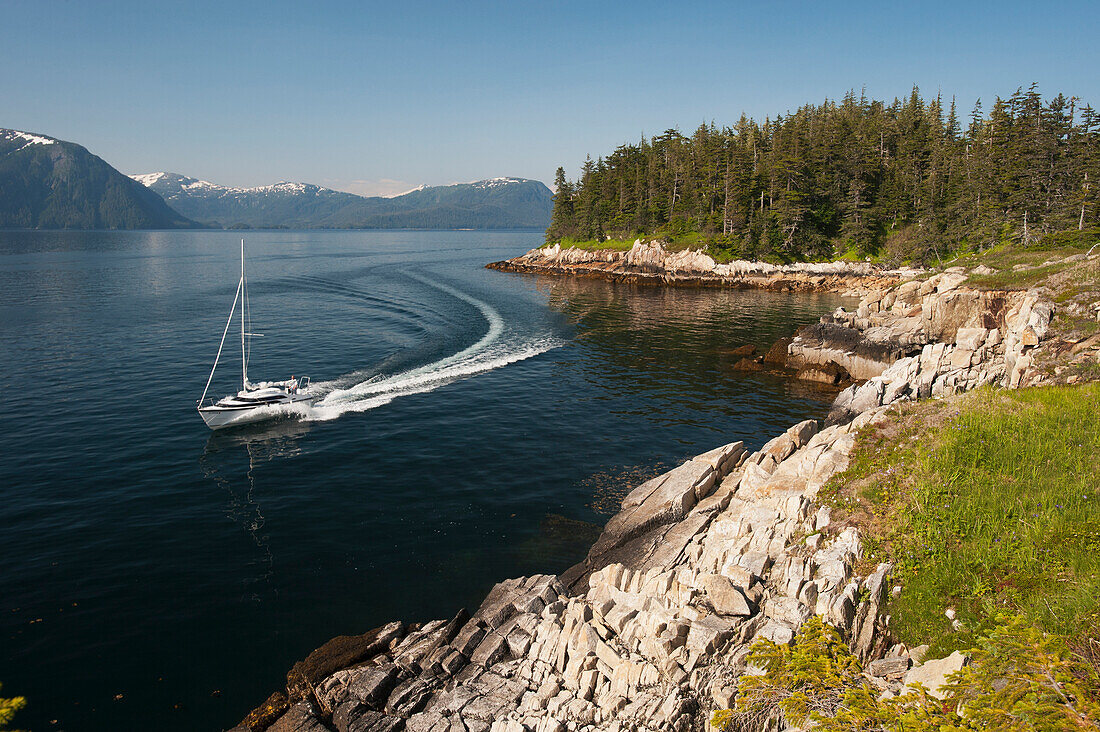 Sailboat passing Perry Island in Prince William Sound, Southcentral Alaska.