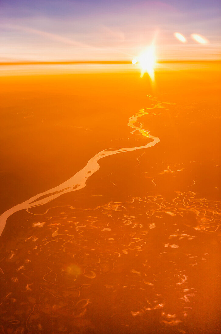 Aerial view of warm light during sunrise with the Kobuk river visible below, Arctic Alaska, summer