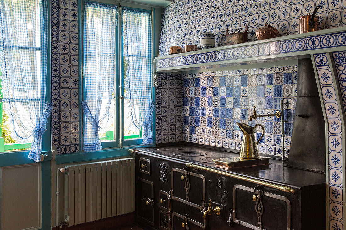 the kitchen in blue tiles from rouen and its multi-oven cooker, the impressionist painter claude monet's house, giverney, eure (27), normandy, france