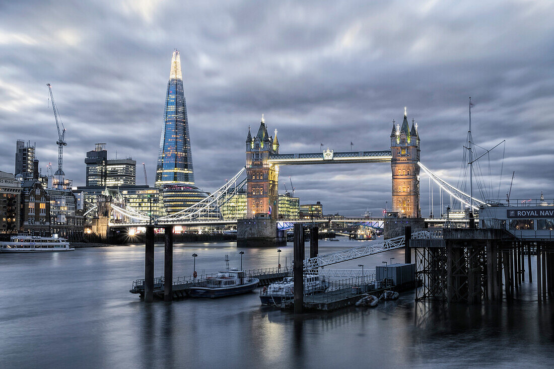 The River Thames, Tower Bridge, City Hall, Bermondsey warehouses and the Shard at night shot from Wapping, London, England, United Kingdom, Europe