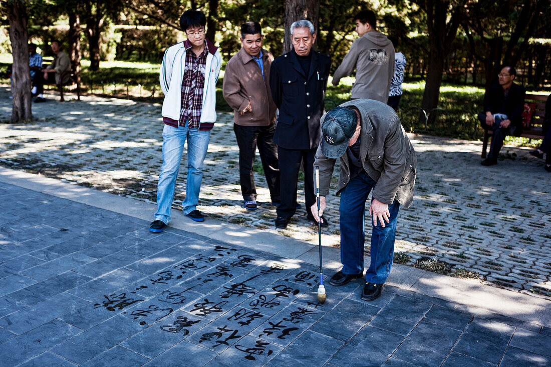 Men doing calligraphy in Tiantan Park, Temple of Heaven, Beijing, China