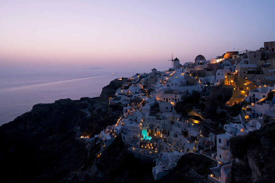 An aerial view of Oia and the windmill at dusk, Oia, Santorini, The Cyclades, The Aegean, The Greek Islands, Greece