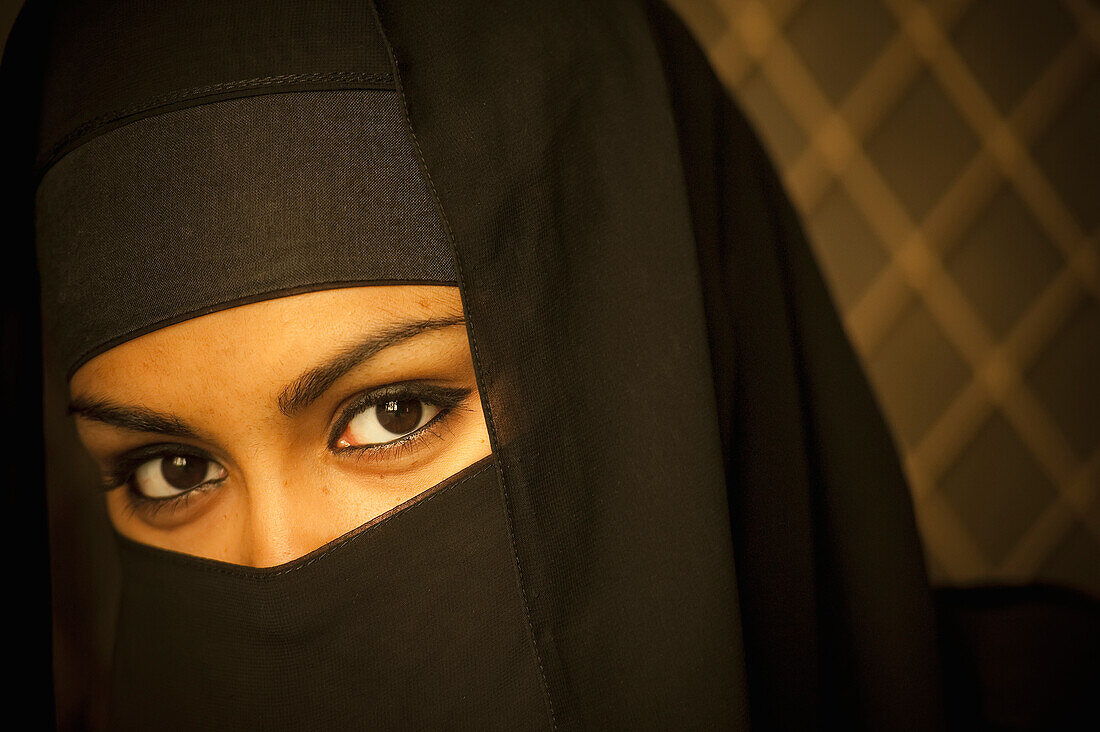 Portrait of a woman wearing a black burka, Brunei