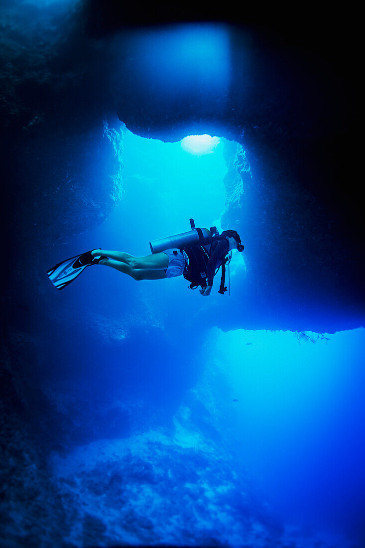 Diving into the Blue Holes underwater caves, Palau, Micronesia