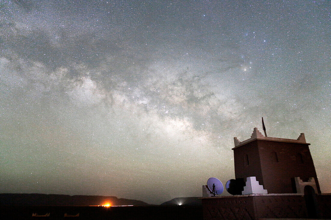 Morocco, Dra Valley, Zagora region, Milky Way and starry sky above a kasbah